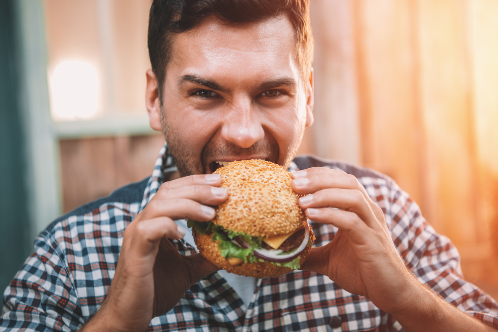 man eating hamburger