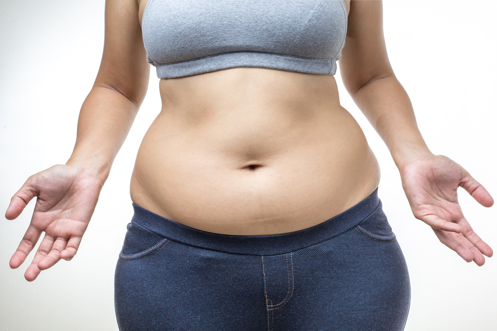 a woman displaying her stomach fat