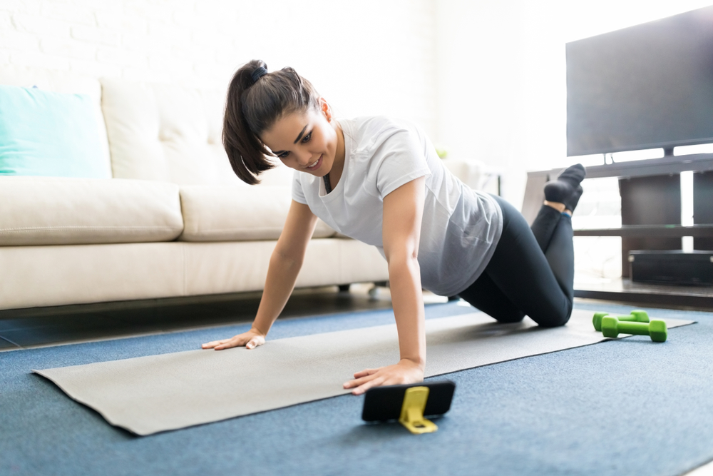 a young woman working out at home